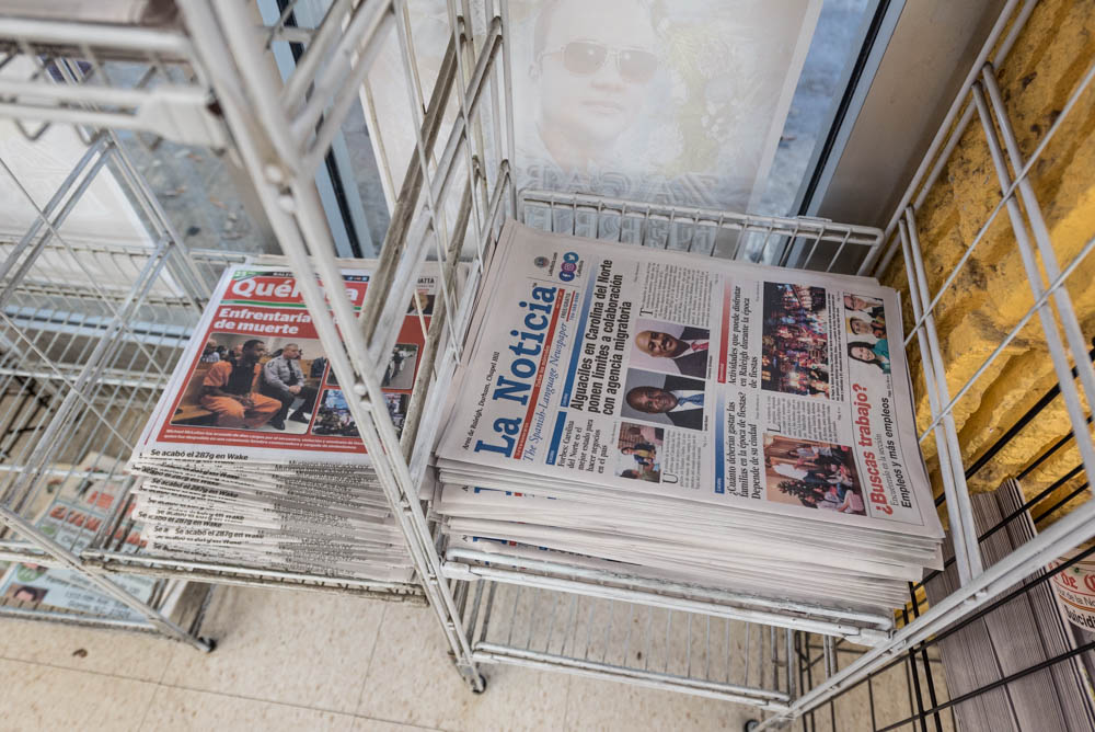 Stacks of Spanish-language newspapers.